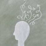 A brain drawn in a black boards with a lot of new connexions showing the benefits of NLP and coaching to learn French