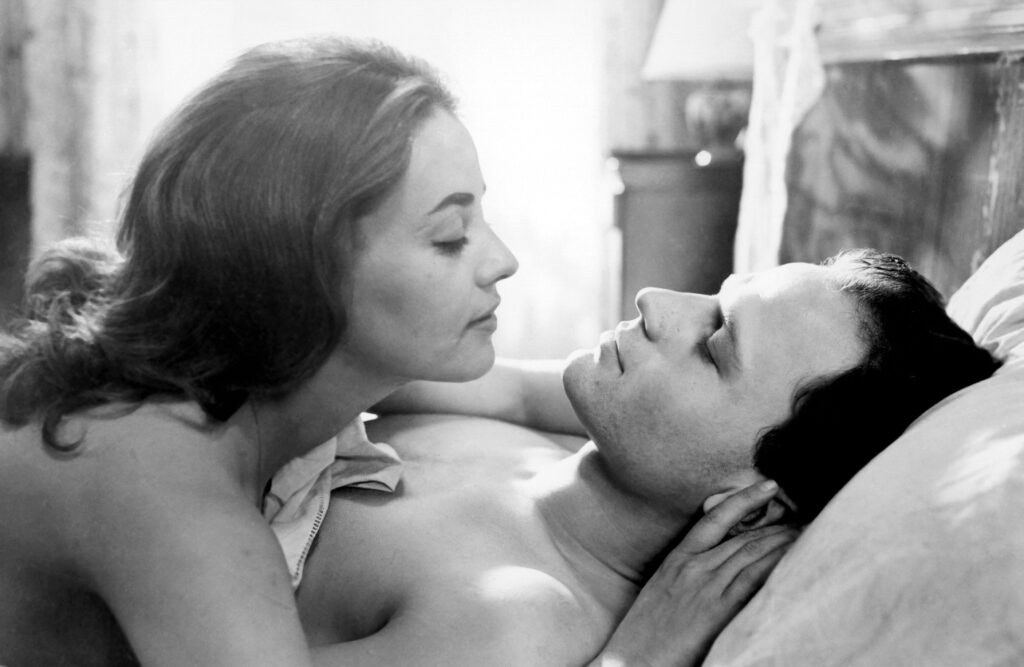 Two lovers look inside each other eyes. The scene, highly romantic and in black and white, is from the French movie "The Lovers".