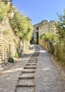 Quaint cobblestone street leading through historic Gordes, Provence, showcasing classic French architecture.