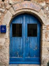 Charming rustic blue door, La Porte Bleue, in a stone facade in Provence, France.