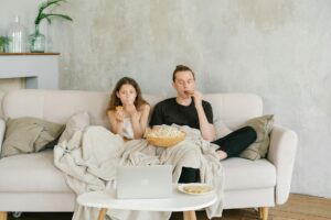 A cozy home movie night with subtitles and a notebook for learning French.