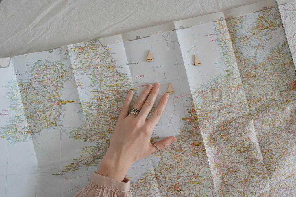 A map of France with books and a laptop for planning a move.