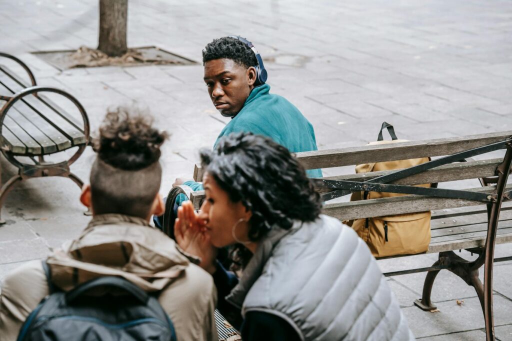 A learner listening carefully during a real French conversation.