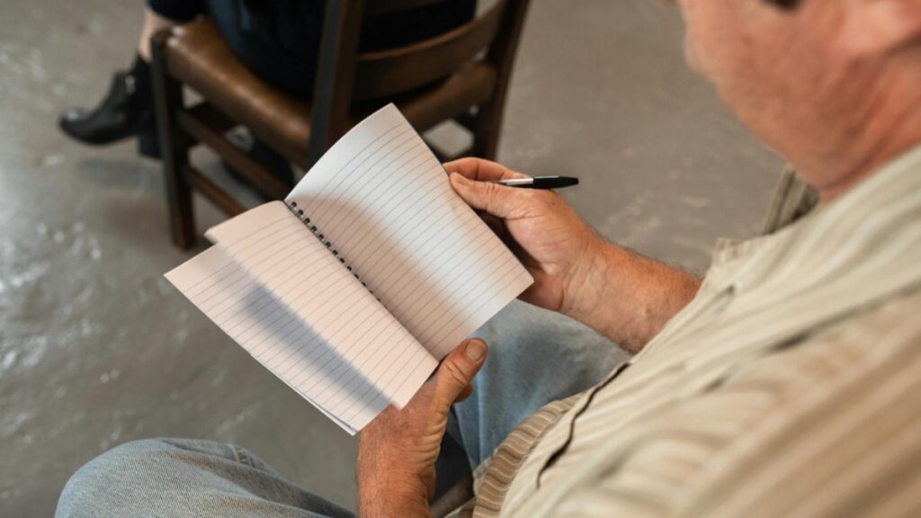 Adult learner studying French at a table during a calm practice session.