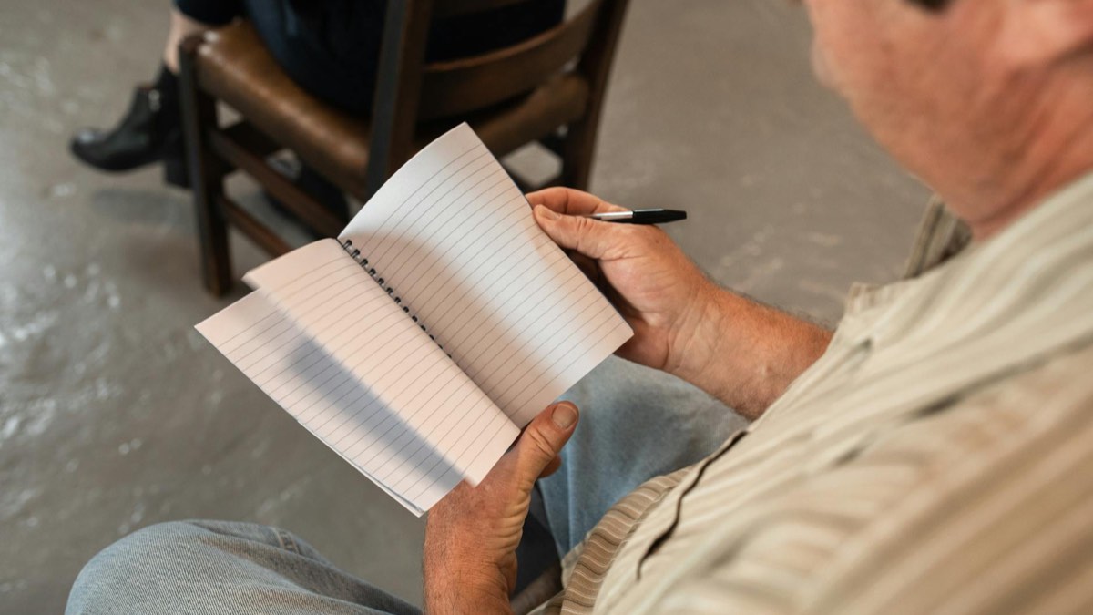 Adult learner studying French at a table during a calm practice session.