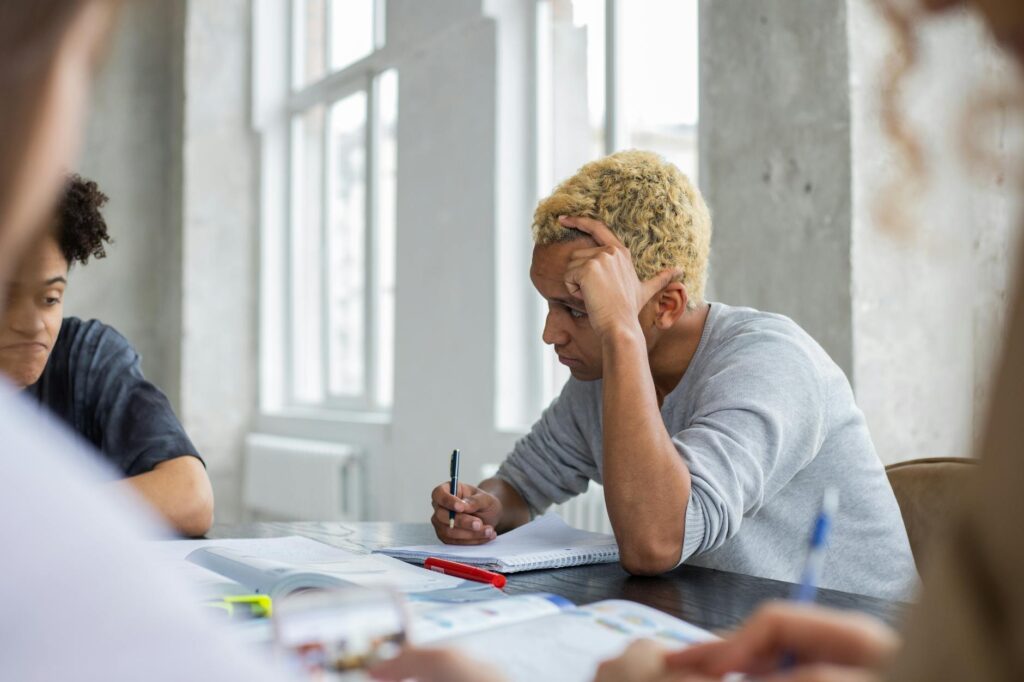 Reference Pexels-style image of an adult learner studying French at a table