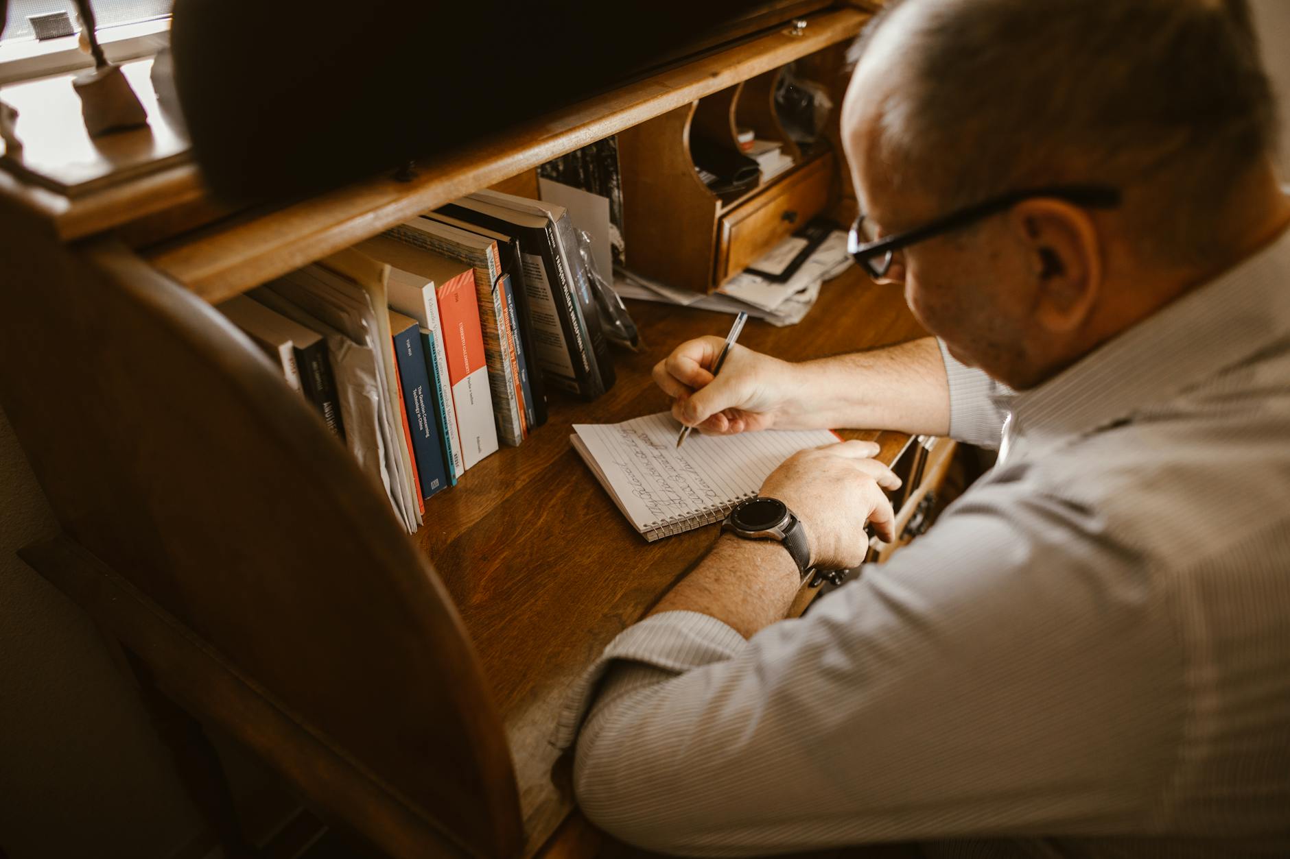Older adult learning French with a notebook