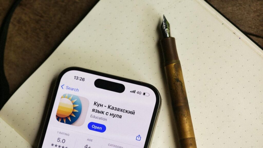Adult learner taking notes during a phone call at home