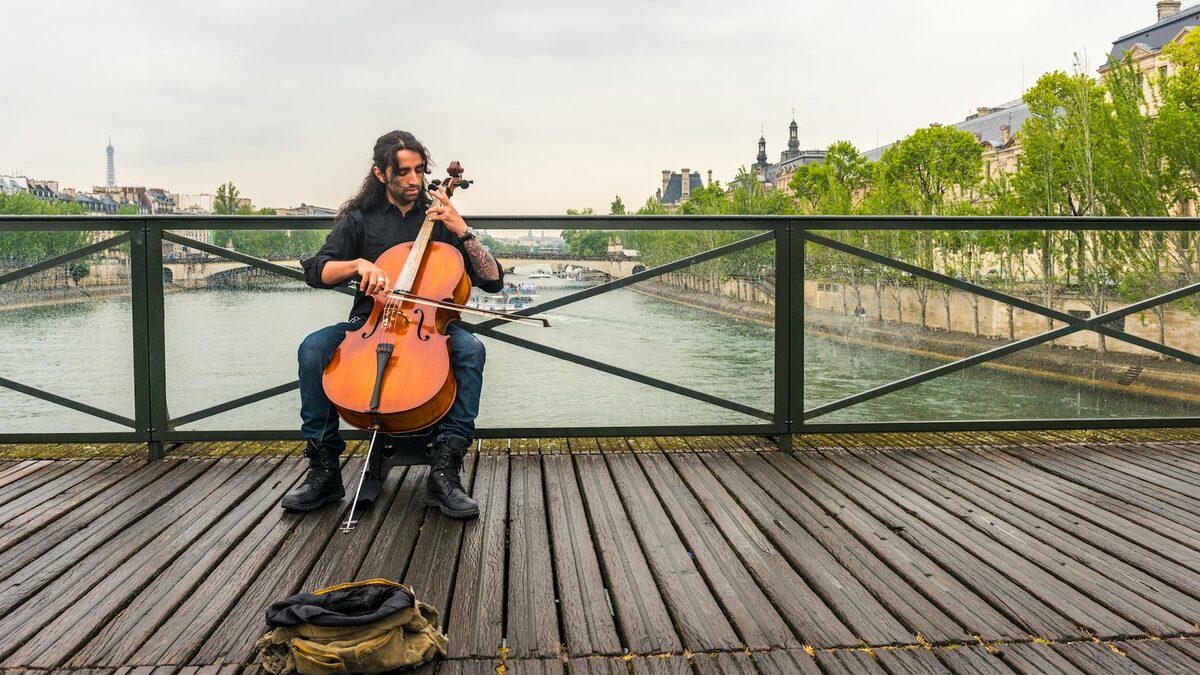 Street musicians performing as people gather on a summer evening in Paris