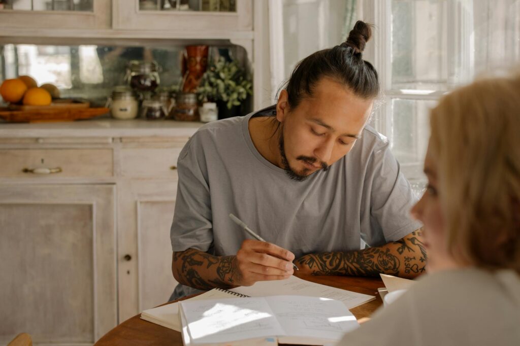 Adult learner writing notes during a calm French study session