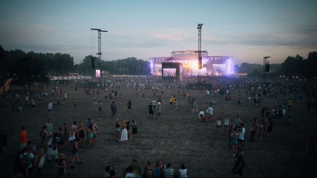 People listening to an outdoor music performance during a French summer festival