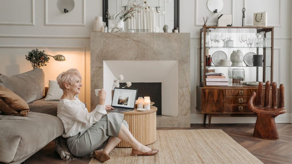 A 50+ adult learner studying French at a kitchen table with notes for everyday life in France