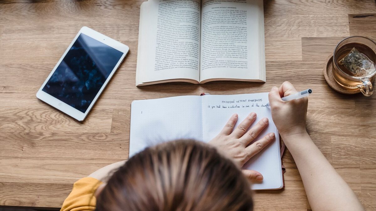 Adult French learner reviewing a small list of practical French phrases for daily life in France
