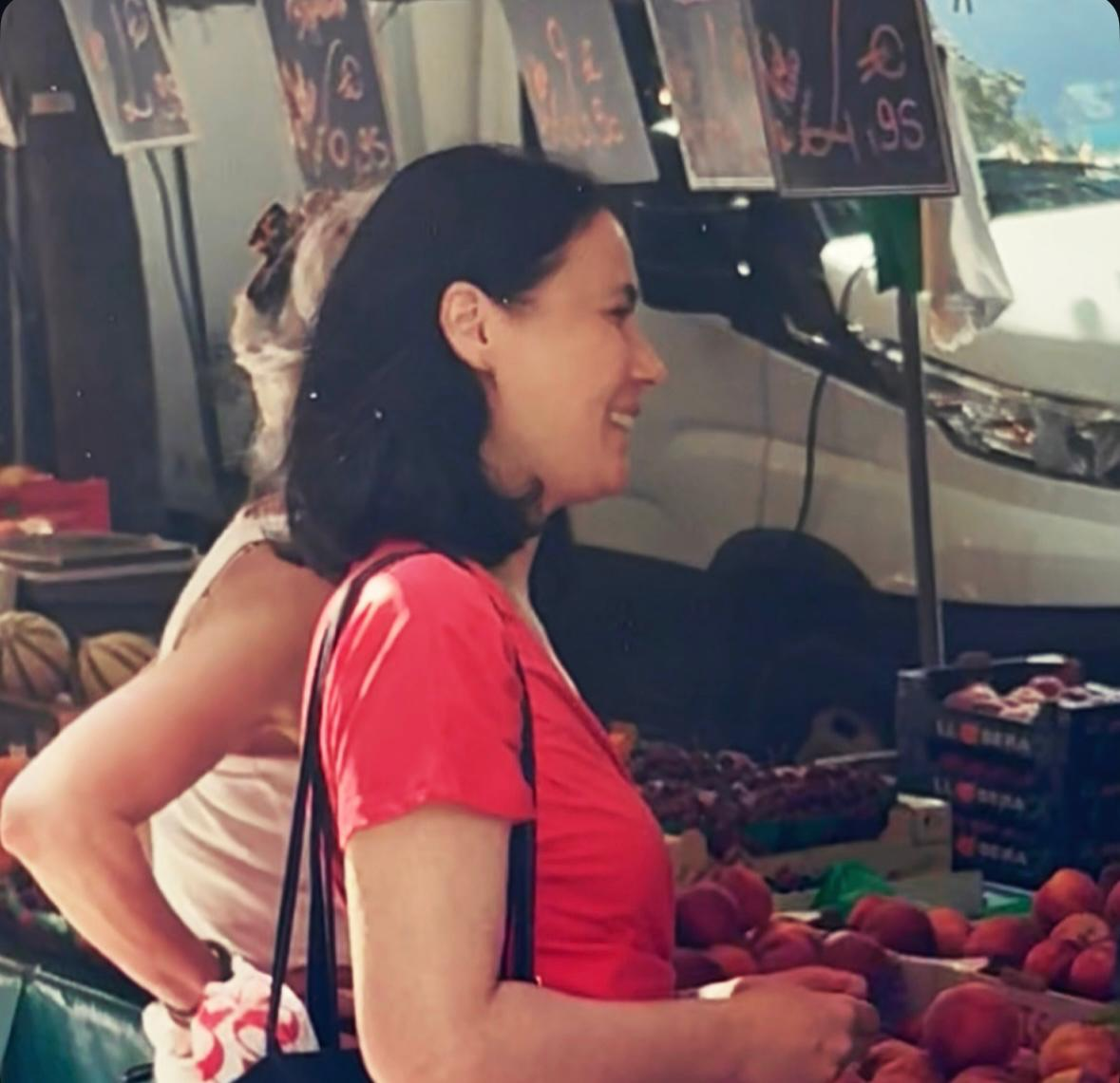 Olivia smiling at a French market