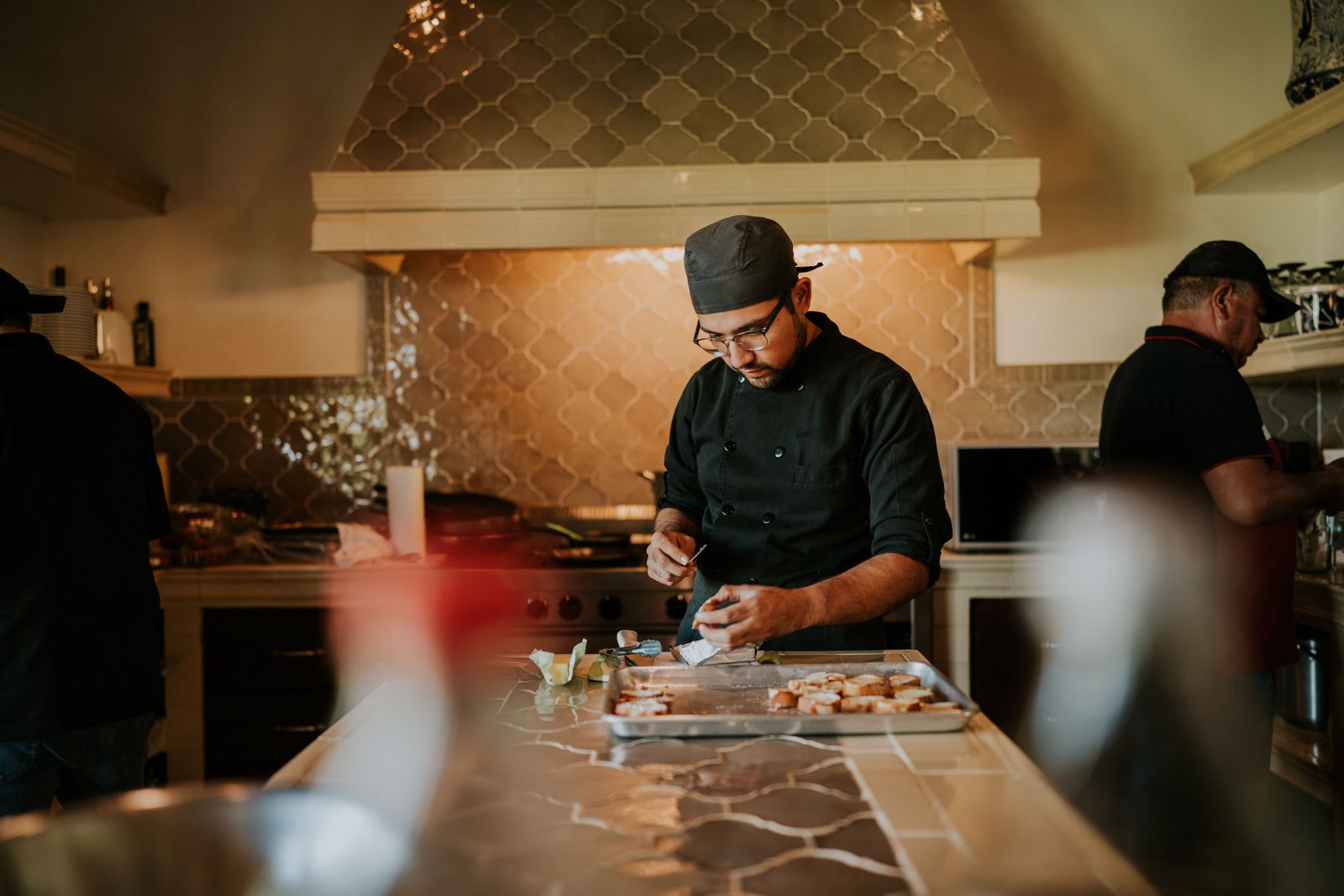 Chef preparing ingredients at a worktop in a professional kitchen
