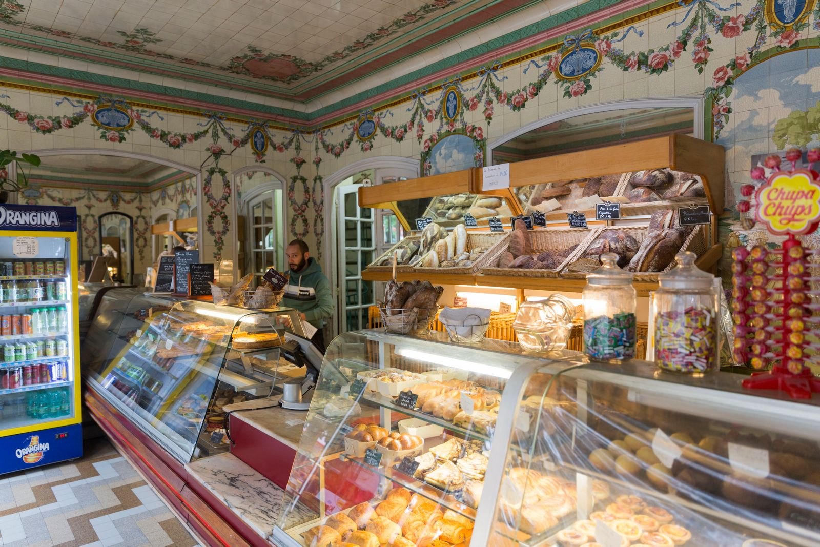 Bread and pastries displayed behind the counter of a bakery in Paris